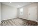 Well-lit bedroom with neutral walls, sleek flooring, a large window, and an interior door at 3936 Sterling Dr, Whitestown, IN 46075