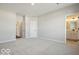 Spacious main bedroom featuring neutral carpet, two doors, and an en-suite bathroom at 3936 Sterling Dr, Whitestown, IN 46075