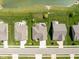 Stunning aerial view of homes with lush green lawns and a serene pond in a well-maintained neighborhood at 4659 W Otway Ln, New Palestine, IN 46163