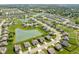 Beautiful aerial view of a neighborhood featuring lush green lawns, ponds, and well-maintained homes at 4659 W Otway Ln, New Palestine, IN 46163