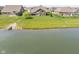 A house has a lush green backyard with an elegant patio by the edge of a peaceful pond at 4659 W Otway Ln, New Palestine, IN 46163