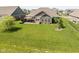 Beautiful backyard featuring a stone patio and lush lawn, perfect for outdoor entertaining and relaxation at 4659 W Otway Ln, New Palestine, IN 46163