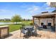 Backyard patio featuring outdoor dining and a gazebo, all overlooking a tranquil pond view at 4659 W Otway Ln, New Palestine, IN 46163