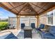 Charming backyard patio under a gazebo, offering comfortable seating around a cozy fire pit table at 4659 W Otway Ln, New Palestine, IN 46163