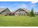 Well-maintained backyard featuring a pristine lawn, patio space, and complemented by landscaping at 4659 W Otway Ln, New Palestine, IN 46163