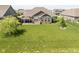 Expansive backyard featuring a stone patio and lush lawn, perfect for outdoor entertaining and relaxation at 4659 W Otway Ln, New Palestine, IN 46163