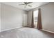 Cozy bedroom with neutral tones, a ceiling fan, carpeted floor, and a window providing natural light at 4659 W Otway Ln, New Palestine, IN 46163