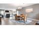 Elegant dining area with a wooden table, a chandelier, and views into the living room at 4659 W Otway Ln, New Palestine, IN 46163
