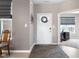 Welcoming entryway with a decorative door, modern gray walls, and hardwood-style floors at 4659 W Otway Ln, New Palestine, IN 46163