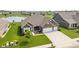 Attractive brick home featuring a well-kept lawn and ample parking space with its extended driveway and three-car garage at 4659 W Otway Ln, New Palestine, IN 46163