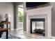 Living room close-up featuring a fireplace with a mounted TV above it, enhanced by natural light at 4659 W Otway Ln, New Palestine, IN 46163