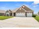 Stunning brick home with a spacious three-car garage, expansive driveway, and well-kept front yard at 4659 W Otway Ln, New Palestine, IN 46163