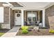 Inviting front porch with stylish seating and stone accents, perfect for relaxing outdoors at 4659 W Otway Ln, New Palestine, IN 46163