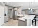 Modern kitchen with stainless steel refrigerator, stylish cabinetry, and an adjacent living area at 4659 W Otway Ln, New Palestine, IN 46163