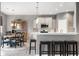 Open kitchen featuring a breakfast bar, stainless steel appliances, and modern pendant lighting at 4659 W Otway Ln, New Palestine, IN 46163