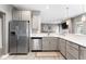 Bright kitchen featuring stainless steel appliances, light countertops, and modern cabinetry at 4659 W Otway Ln, New Palestine, IN 46163