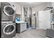 Well-equipped laundry room with modern washer and dryer units, cabinets, and functional countertops at 4659 W Otway Ln, New Palestine, IN 46163