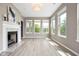 Bright living room filled with natural light, featuring a fireplace and multiple large windows at 4659 W Otway Ln, New Palestine, IN 46163