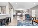 Bright, open floor plan with sleek flooring, comfortable seating, and a view of the entryway at 4659 W Otway Ln, New Palestine, IN 46163