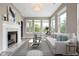 Bright living room featuring a fireplace, large windows, and a comfortable white sofa with stylish pillows at 4659 W Otway Ln, New Palestine, IN 46163