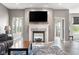 Inviting living room with a cozy fireplace and neutral decor, creating a warm atmosphere at 4659 W Otway Ln, New Palestine, IN 46163