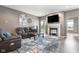 Inviting living room with a cozy fireplace, a large television, and comfortable leather seating at 4659 W Otway Ln, New Palestine, IN 46163