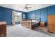 Spacious main bedroom with blue accent wall and natural wood furniture at 4659 W Otway Ln, New Palestine, IN 46163