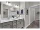 Bathroom featuring double sinks, quartz countertop, and view into shower at 5151 Nettleton Way, Avon, IN 46123