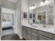 Bathroom featuring double sinks, quartz countertop, and view into bedroom at 5151 Nettleton Way, Avon, IN 46123