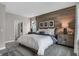 Comfortable bedroom with wood accent wall, view to hall and well-lit windows at 5151 Nettleton Way, Avon, IN 46123