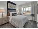 Comfortable bedroom with a wooden headboard, coordinated decor, and natural light at 5151 Nettleton Way, Avon, IN 46123