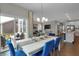 Elegant dining room features modern lighting, blue chairs, and access to an outdoor area at 5151 Nettleton Way, Avon, IN 46123