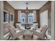 Stylish flex room featuring wood-look walls, neutral furniture, and a decorative chandelier at 5151 Nettleton Way, Avon, IN 46123