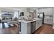 Modern kitchen island with stainless steel appliances that opens to a living room at 5151 Nettleton Way, Avon, IN 46123
