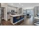 Spacious kitchen with island seating and a view into the dining and living areas at 5151 Nettleton Way, Avon, IN 46123