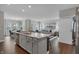 Modern kitchen with island seating, stainless appliances, and an open concept to the living area at 5151 Nettleton Way, Avon, IN 46123