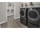 Bright laundry room with sleek, modern washer and dryer and ample shelving and storage space at 5151 Nettleton Way, Avon, IN 46123