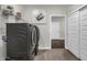 Laundry area with a side-by-side washer and dryer, shelving for storage, and white trim at 5151 Nettleton Way, Avon, IN 46123