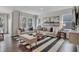 Bright living room features stylish furniture, striped rug, and natural light from large windows at 5151 Nettleton Way, Avon, IN 46123