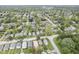 An elevated shot showcases a house, surrounded by dense trees, highlighting its location within a vibrant neighborhood at 5225 E St Clair St, Indianapolis, IN 46219