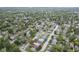 An aerial view captures a house set among mature trees, highlighting its place in a quiet, residential area at 5225 E St Clair St, Indianapolis, IN 46219