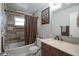 Bathroom with a new vanity, framed mirror, and shower with updated tile surround at 5225 E St Clair St, Indianapolis, IN 46219