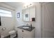 Charming bathroom features a single vanity, toilet, and shower/tub combo at 5225 E St Clair St, Indianapolis, IN 46219