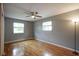 Spacious bedroom featuring hardwood floors, ceiling fan, and ample natural light at 5225 E St Clair St, Indianapolis, IN 46219