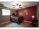 Comfortable bedroom with hardwood floors, an area rug, and unique side table with globe at 5225 E St Clair St, Indianapolis, IN 46219
