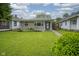 Charming home with a green lawn and flower beds at 5225 E St Clair St, Indianapolis, IN 46219