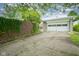 Exterior shot of a two car garage with concrete parking pad and privacy fence at 5225 E St Clair St, Indianapolis, IN 46219