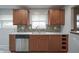Renovated kitchen featuring stainless steel appliances, granite countertops, wine rack, and new tile flooring at 5225 E St Clair St, Indianapolis, IN 46219