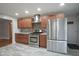 Updated kitchen features stainless steel appliances, mosaic backsplash, and ample cabinet space at 5225 E St Clair St, Indianapolis, IN 46219