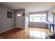 Bright living room features hardwood floors, a large window, and ample space for entertaining at 5225 E St Clair St, Indianapolis, IN 46219
